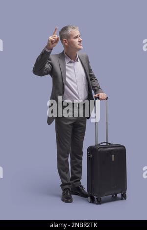 Corporate businessman on a business trip, he is calling a taxi Stock Photo