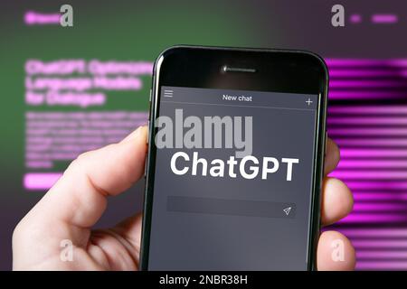Screen of a smartphone with ChatGPT chat, AI tool, artificial intelligence. Man using ChatGPT the AI chatbot by OpenAI. ChatGPT website Stock Photo