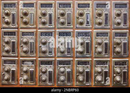 Wooden wall with ancient American safe deposit mail boxes Stock Photo