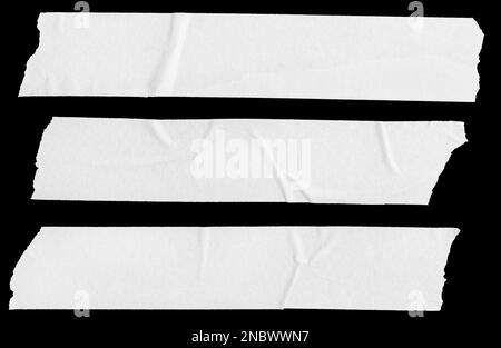 Three white Blank painter tape stickers isolated on black background. Template mockup Stock Photo