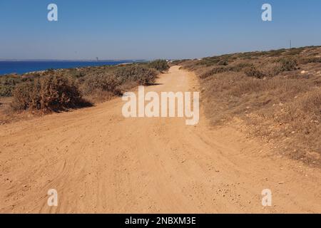 Dust road to Sea Caves area in Cape Greco National Forest Park in Cyprus Stock Photo