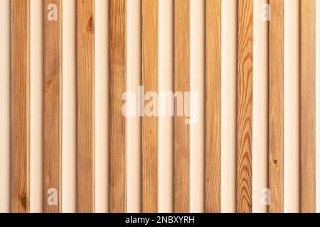 narrow wooden slats on a white plastered wall as an element of modern decor in a minimalistic interior design Stock Photo