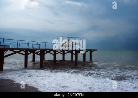 Coast guard is coming to a helicopter during a sea storm Stock Photo