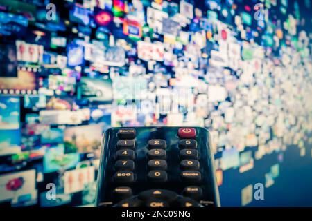 Video on demand (VoD) screen with remote control in foreground Stock Photo
