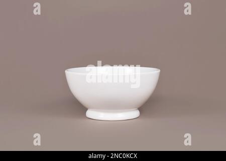 Single empty cereal bowl on brown background Stock Photo