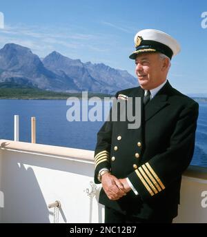 1960s, historical, portrait of the Captain (or Master) of the SS Uganda steamship outside on the deck in full uniform.  Built in 1952 for the British-India Steam Navigation Company as a passenger and cargo liner, she sailed between London and East Africa.  The rise in civil aviation, saw a decline in demand and so she was converted to an educational cruise ship in the late 1960s, when her cargo holds were changed into dormitory cabins. She then sailed in Scandinavia and the Mediterranean up until 1982, when she was used by the Royal Navy as a hospital ship in the Falklands War. Stock Photo