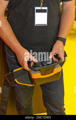 Worker Holding Remote Control With Joysticks for Construction Machinery Stock Photo