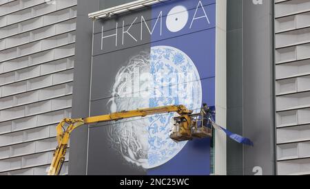 Workers replace posters on the exterior wall of the Hong Kong Museum of Art on a crane in Tsim Sha Tsui. 08FEB23  SCMP / Jelly Tse Stock Photo