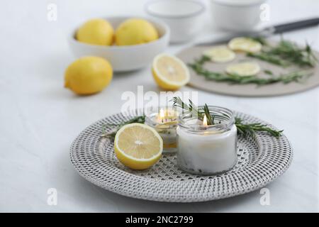 Natural homemade mosquito repellent candle and ingredients on white table Stock Photo