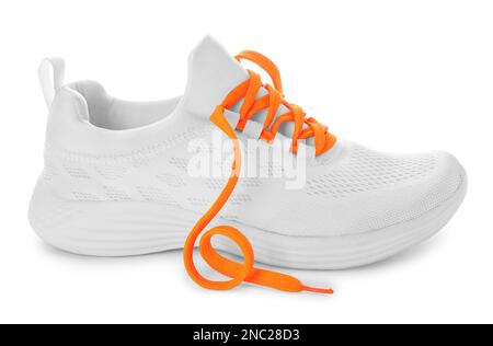 Stylish sneaker with orange shoelaces on white background Stock Photo