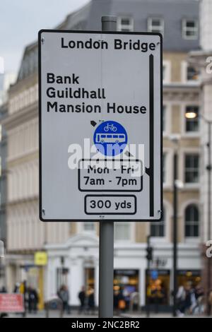 A street sign in London directs traffic towards London Bridge, Bank, Guildhall and Mansion House. Also indicates road ahead is a bus lane. Stock Photo