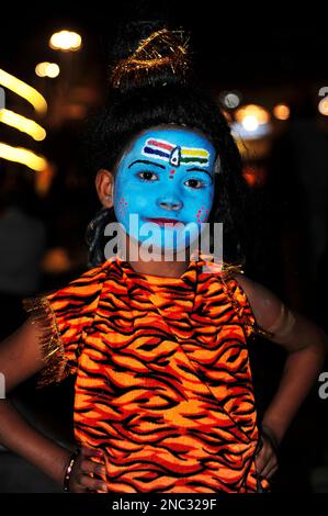 Indian girl, face painted as the Hindu god Shiva. Varanasi, India Stock Photo