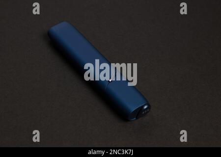 Iqos electronic blue cigarette on a beige background Stock Photo - Alamy