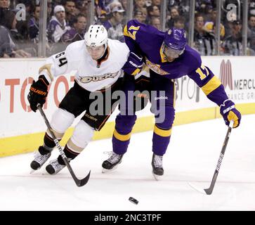 Los Angeles Kings center Wayne Gretzky, left, maneuvers the puck as Quebec  Nordiques goalie Stephane Fiset covers the goal in the first period of  Tuesday's NHL game at the Forum in Inglewood