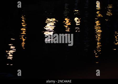 Reflection of lights on the water surface, Speicherstadt, Hamburg, Germany. Abstract background. Stock Photo