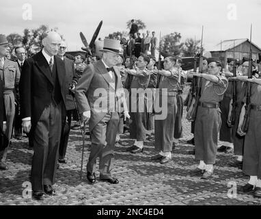 Winston Churchill, former Prime Minister of Great Britain, and guest of honor of the city of Metz, France on July 14, 1946 in celebration of Bastille Day, reviews French troops with French Finance Minister Robert Schuman, left. (AP Photo)