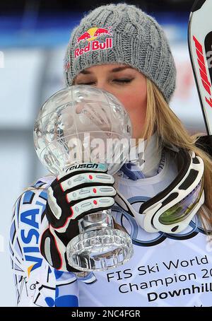 U.S. skier Lindsey Vonn kisses her trophy of the women's World Cup downhill discipline title, at the World Cup finals in Lenzerheide, Switzerland, Wednesday, March 16, 2011. (AP Photo/Armando Trovati)