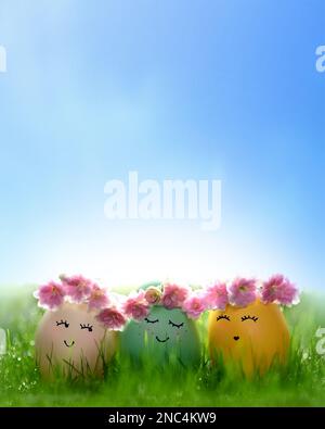 Row of three Easter eggs in fresh green grass. Holiday concept. Stock Photo