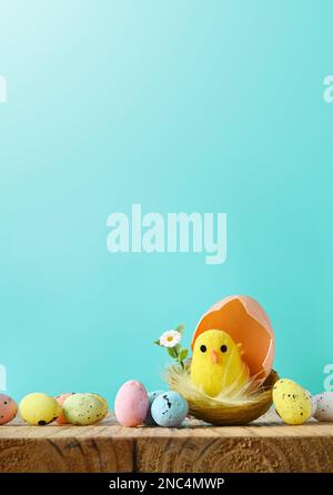 Easter eggs and yellow chick on a blue background. The minimal concept. Easter card. Stock Photo