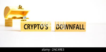 Crypto downfall symbol. Concept words Cryptos downfall on wooden blocks. Beautiful white table white background. Wooden chest with coins. Business and Stock Photo