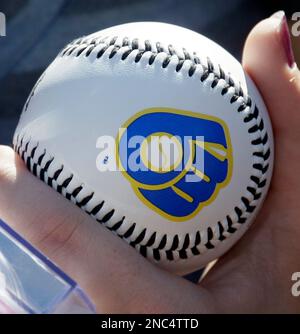 A baseball fan holds a ball as he waits to get an autograph from Chicago  White Sox's Jake Burger before a baseball game between the Kansas City  Royals and the Chicago White