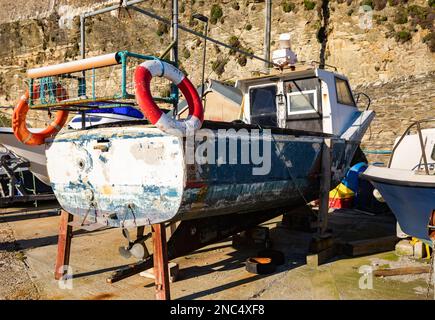 Portreath,Cornwall,14th February 2023,A fishing boat sitting on the harbour wall at low tide in Portreath,Cornwall. The sky was blue with glorious sunshine and 10C, the forecast after today is variable for the next few days.Credit: Keith Larby/Alamy Live News Stock Photo