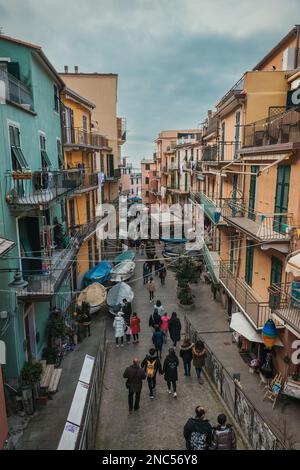 Street in touristic town, Manarola, Italy. Cinque Terre National Park. Sunny Sunset Stock Photo