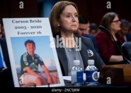 Washington, United States Of America. 14th Feb, 2023. Kristin Bride, Survivor Parent and Social Media Reform Advocate, sits next to a photo of her 16-year-old son Carson Bride as she appears before a Senate Committee on the Judiciary hearing to examine protecting our children online, in the Hart Senate Office Building in Washington, DC, Tuesday, February 14, 2023. After being cyberbullied, Carson took his own life on June 23, 2020. Credit: Rod Lamkey/CNP/Sipa USA Credit: Sipa USA/Alamy Live News Stock Photo