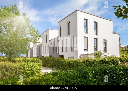 Cityscape with modern townhouses in a residential area, new apartment buildings with green outdoor facilities in sustainable enviroment Stock Photo