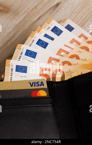Brussels, Belgium, February 2023 -EURO banknotes in a wallet with with Visa and Mastercard Stock Photo