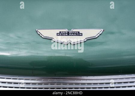 Aston Martin emblem on the hood of a classic 1960 Aston Martin DB4 Series 1 sports car. Stock Photo