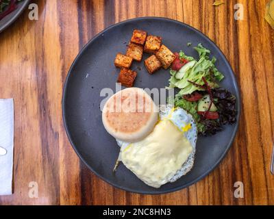 A breakfast sandwich of a fried egg with cheese on an English Muffin in a restaurant in Oaxaca, Mexico. Stock Photo