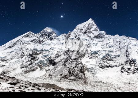 Everest mountain panoramic view on a starry night. Beautiful night mountain landscape under bright moonlight. Bright stars shining above Everest peak. Stock Photo
