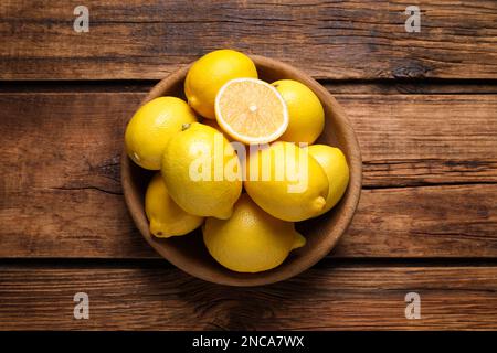 Many fresh ripe lemons on wooden table, top view Stock Photo