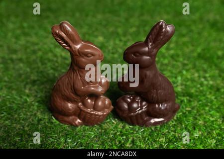 Chocolate bunnies on green grass. Easter celebration Stock Photo