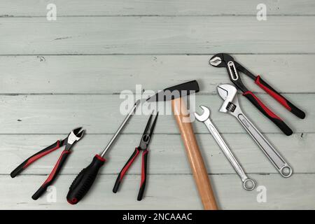 Set of working tools lying on white painted boards. View from above. Stock Photo