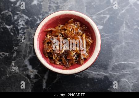 Modern hookah bowl with tobacco on black marble table, top view Stock Photo