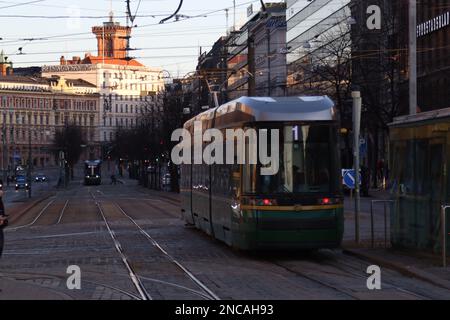 Public Tram With The Number Of The 1 Route Departs From A Stop On Mannerheim Avenue In Helsinki. Street In Kluuvi District In Evening Or Night Illumi Stock Photo