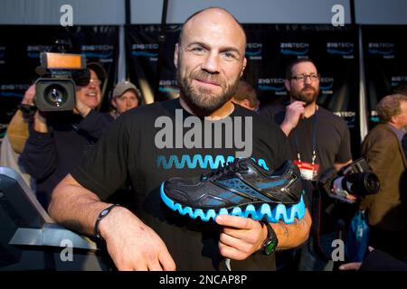 Randy Couture holds a Reebok ZigTech footwear during the Reebok ZigTech  Cowboy Up Challenge in Dallas on February 4, 2011 where top athletes and  celebrities showed the media the power of ZigTech