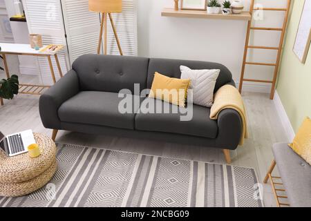 Stylish living room interior with comfortable sofa and lamp Stock Photo