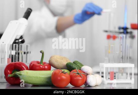 Fresh vegetables on table in laboratory. Food quality control Stock Photo