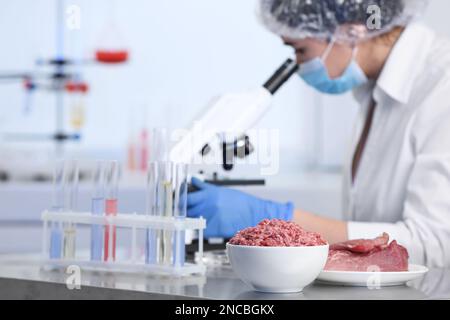 Scientist proceeding quality control in laboratory. Meat analysis Stock Photo
