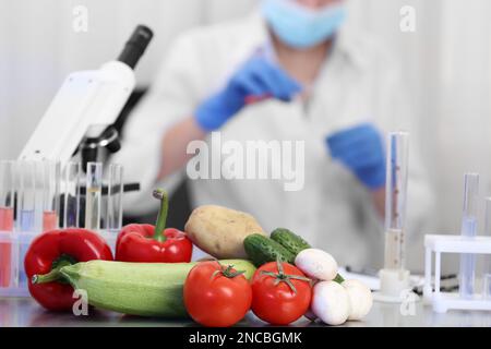 Fresh vegetables on table in laboratory. Food quality control Stock Photo