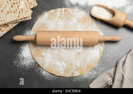 Matzos and raw dough on grey table, flat lay Stock Photo