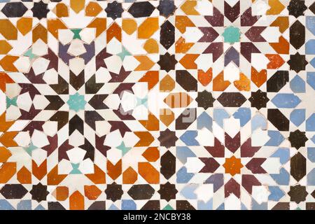 Moroccan Islamic mosaic tiles. Authentic geometric pattern wall tiles in Marrakesh, Morocco Stock Photo