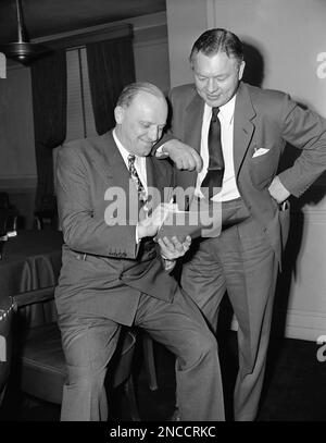 FILE - This Jan. 18, 1947, file photo shows Chicago Bears owner and coach  George Halas, left, watching as Bob Fenimore signs a contract with the Bears.  Halas left the Bears in