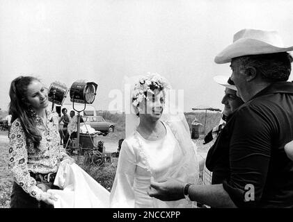 Federico Fellini, the Italian film director, at right gives instructions to French actress Magali Noel (wearing wedding gown) on set of the movie “Amarcord” near Bologna, Italy in 1973. The movie was awarded the Oscar prize as best film in foreign language on April 9, 1975 in Santa Monica, California. Others unidentified. (AP Photo)
