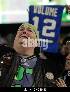 Seattle Seahawks superfan Lorin Big Lo Sandretzky watches game action  holding a t-shirt featuring Seattle Seahawks' Marshawn Lynch during an NFL  football game against the Arizona Cardinals, Sunday, Oct. 24, 2010, in