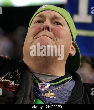 Seattle Seahawks superfan Lorin Big Lo Sandretzky watches game action  holding a t-shirt featuring Seattle Seahawks' Marshawn Lynch during an NFL  football game against the Arizona Cardinals, Sunday, Oct. 24, 2010, in