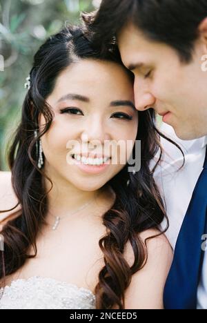 Groom hugs smiling bride. Portrait Stock Photo